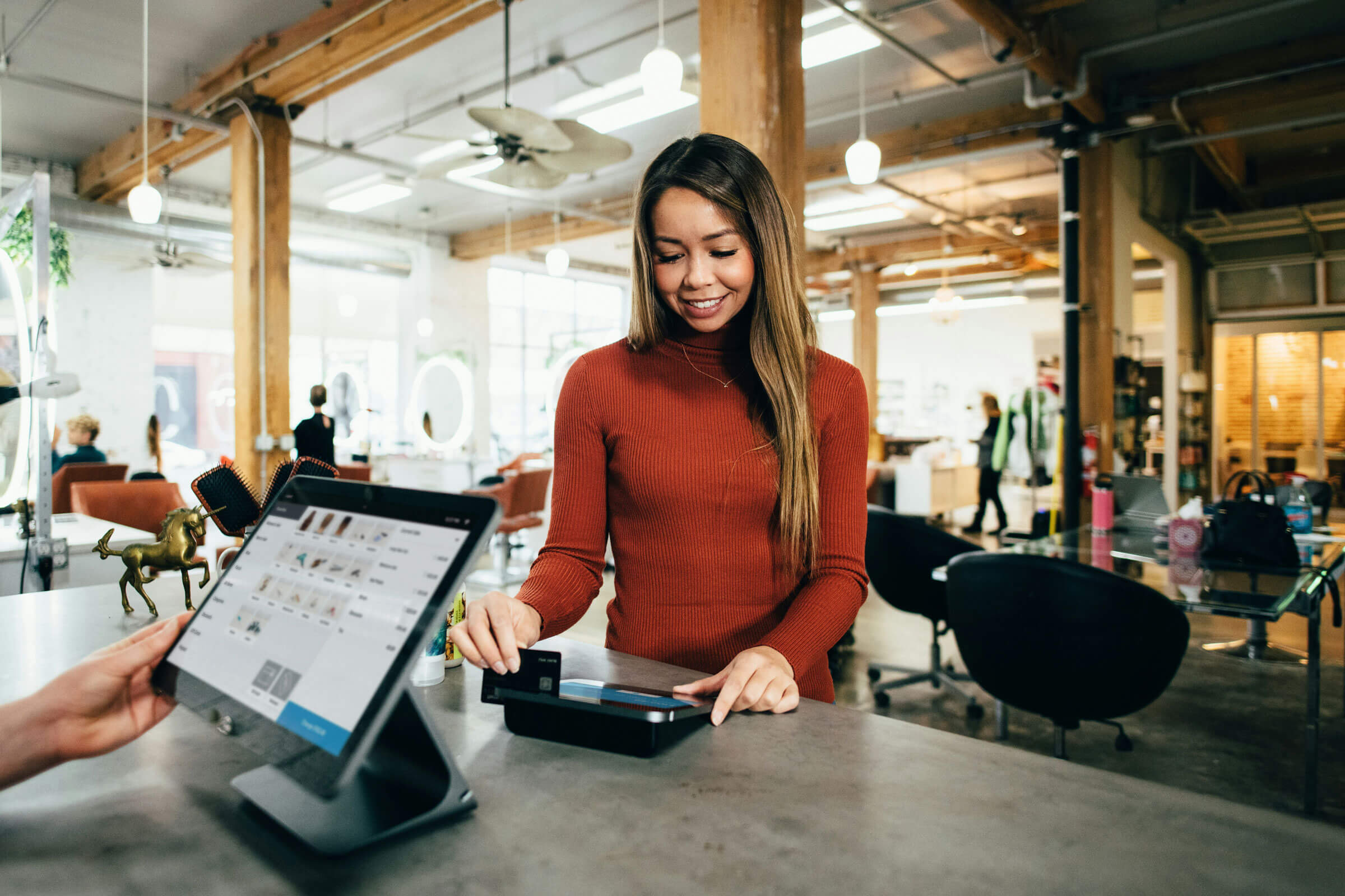 Woman paying by credit card in a store.