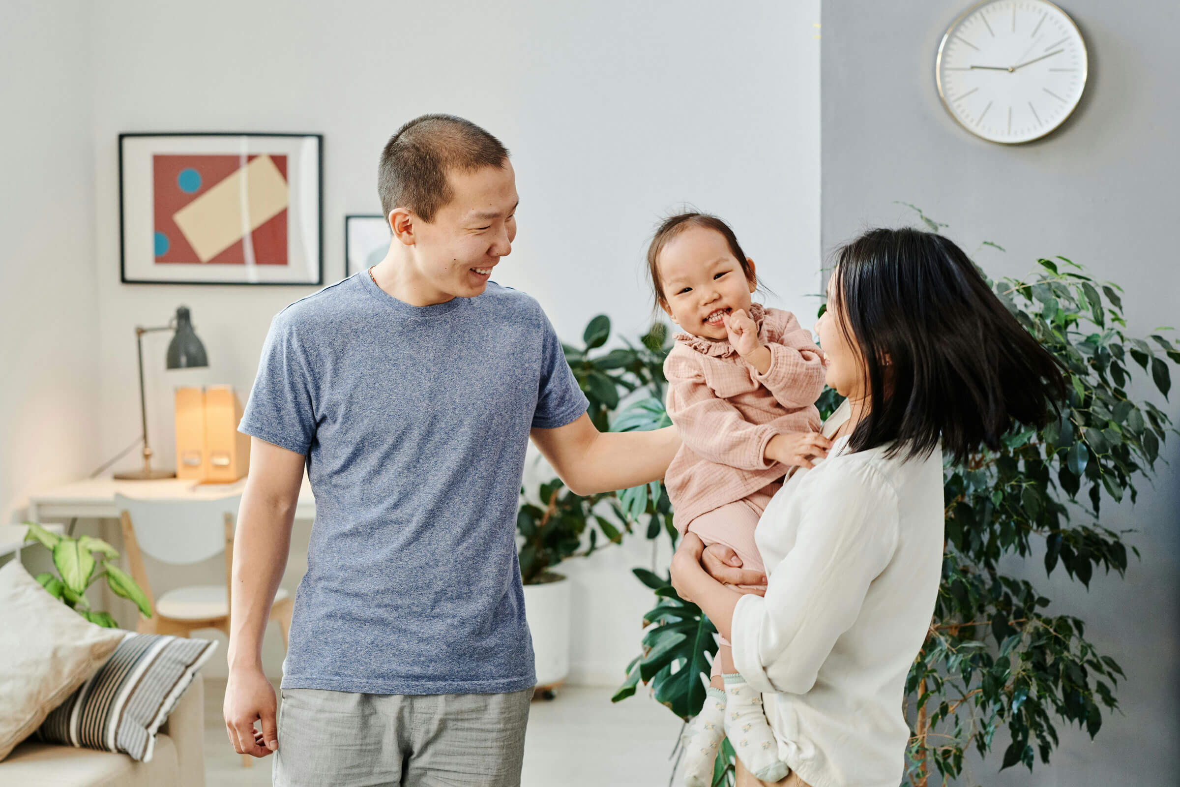 Smiling Asian couple with smiling baby.